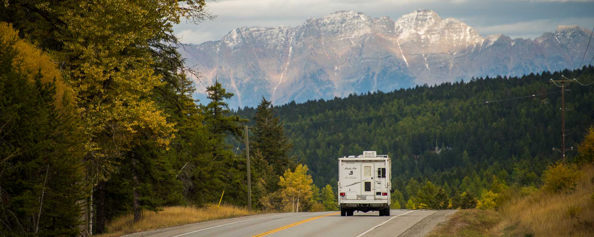 A camper on Highway 3 heads east towards the Canadian Rockies.